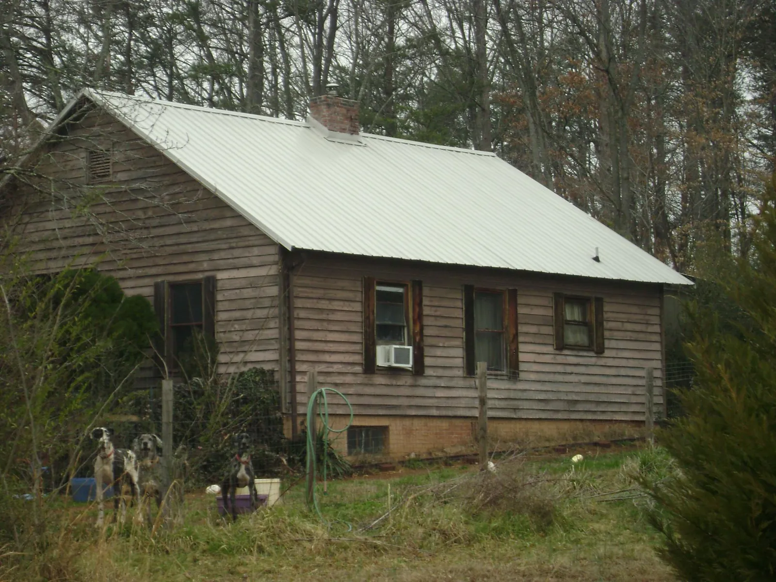 White metal roof on an old wood sided farmhouse, from a Metal Roof Installation job in Altadena